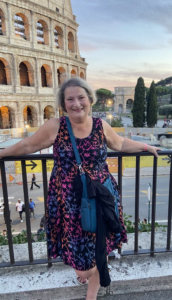 Carol Cram in front of the Colosseum in Rome