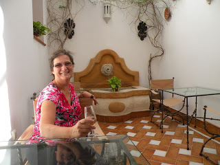 The author with a glass of sherry in the courtyard of a hotel in Cordoba