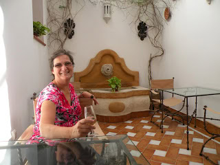 The author with a glass of sherry in the courtyard of a hotel in Cordoba