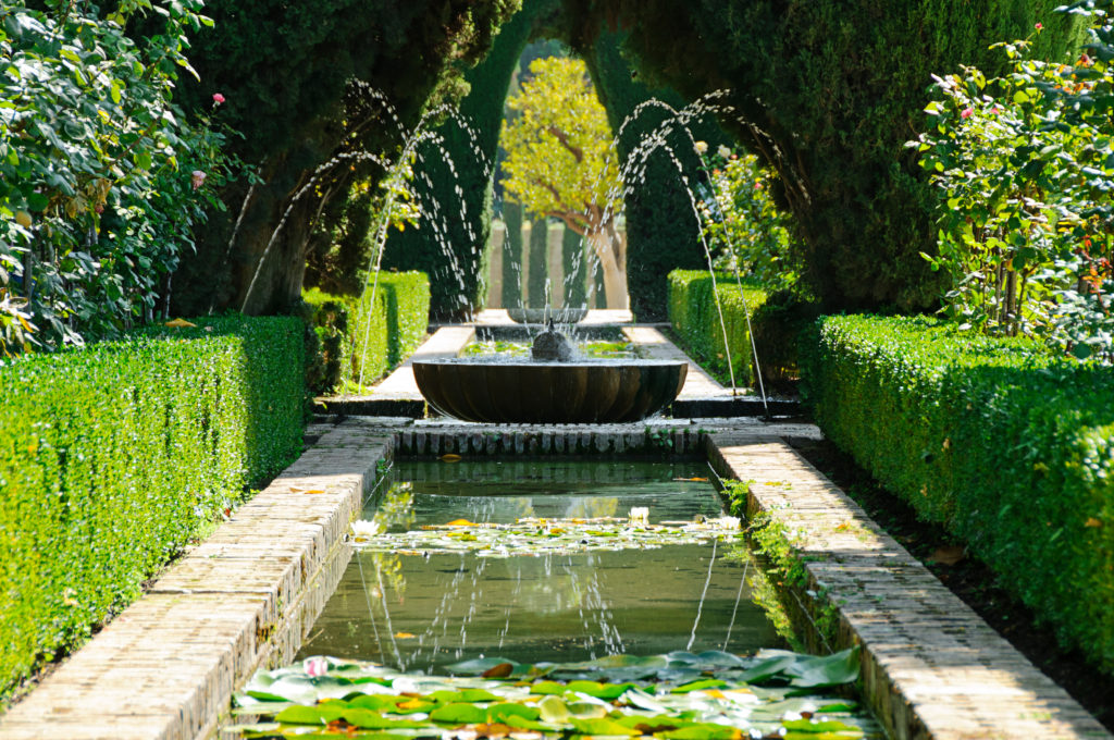 Water games and beautiful vegetation in the gardens of the Generalife on the hill of the Alhambra
