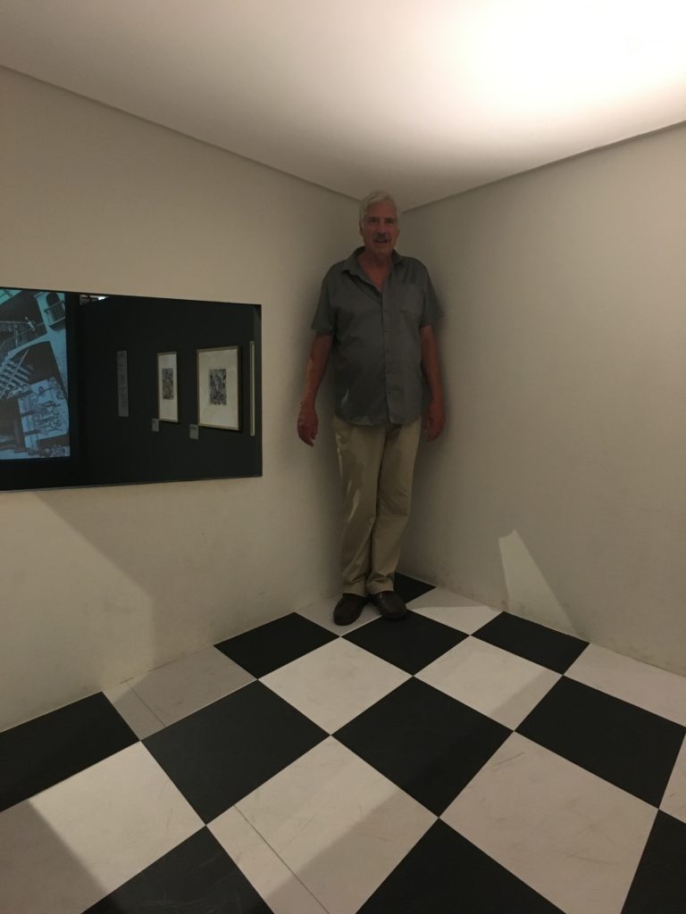 Gregg Simpson in the M. C. Escher exhibition - optical illusion makes him look tall