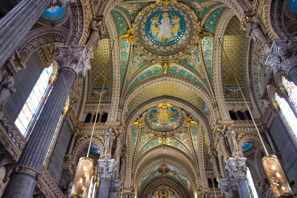 Interior of La Basilique Notre Dame de Fourvière in Lyon showing the frescoed ceiling