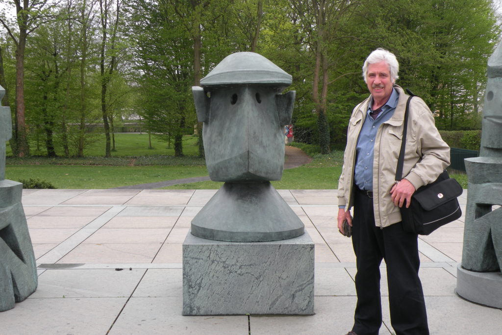 Gregg Simpson next to a Max Ernst statue on the grounds of the Max Ernst Museum in Brühl 