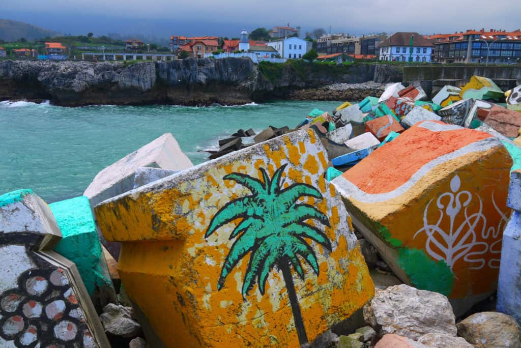 Painted cement blocks on the breakwater in Llanes, Spain