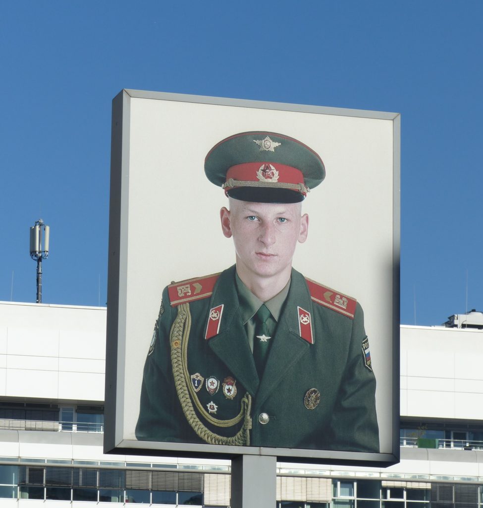Photograph of a young Soviet soldier at Checkpoint Charlie in Berlin
