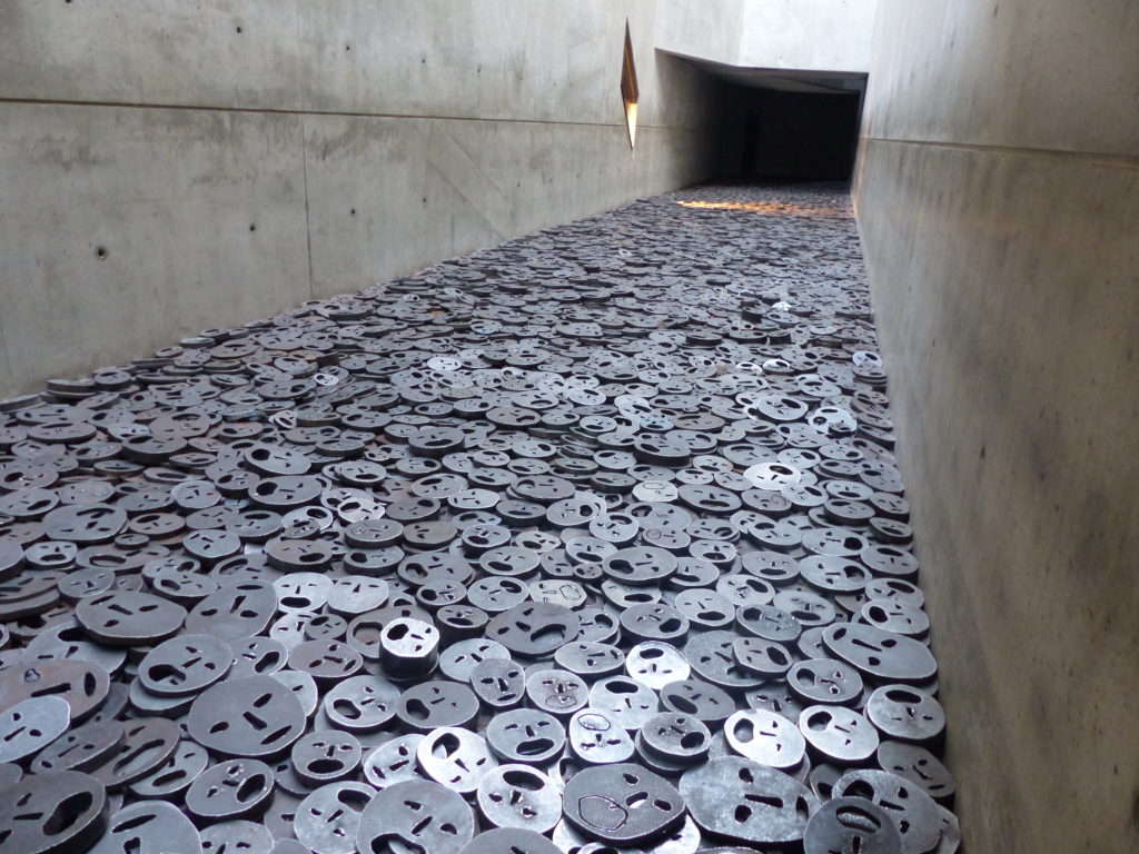 Room of metal discs representing upturned faces in the Jewish Museum