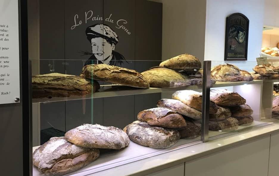 Shelf of fresh baked bread at a boulangerie in Lyon, France
