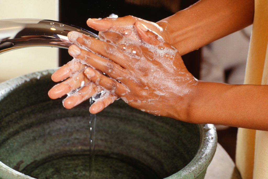 Close up of hands being washed -- clean hands contribute to healthy travel in Europe