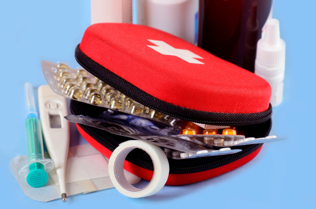 First aid kit containing pills, thermometers, bandages - essential for healthy travel in Europe