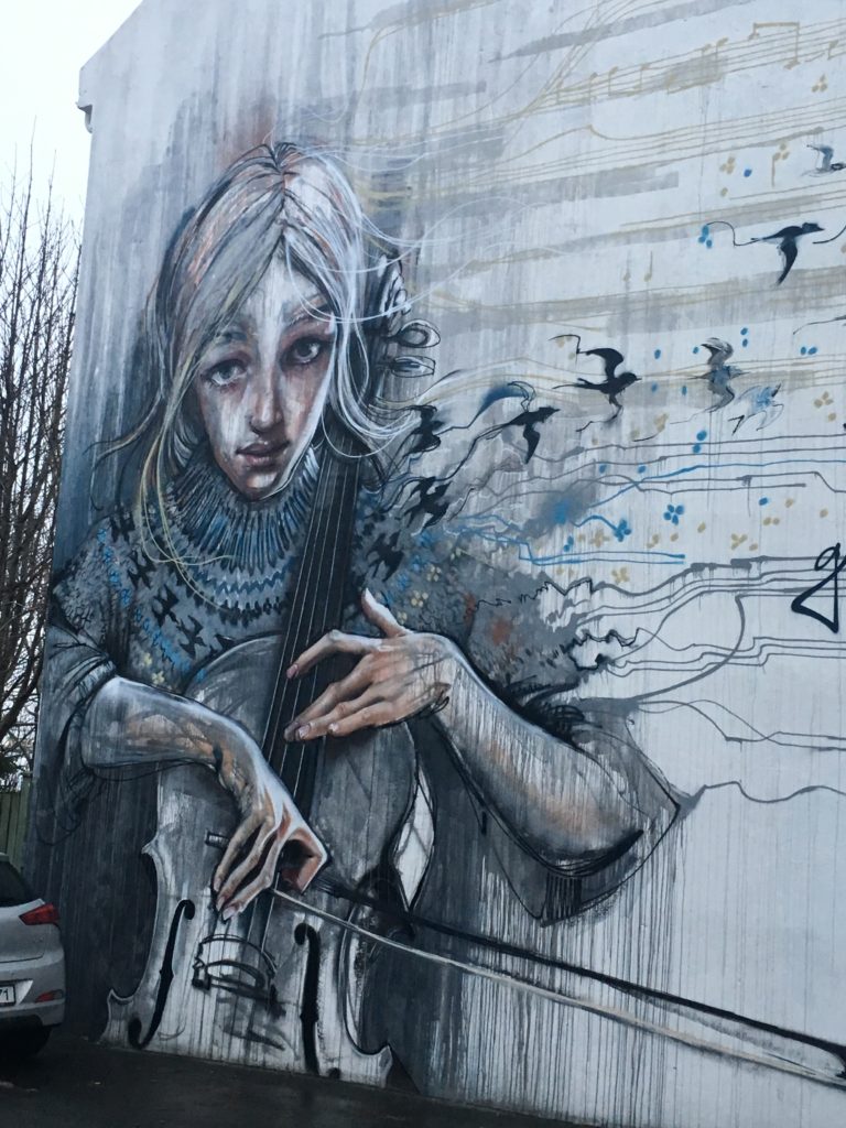Wall mural in Reykjavik showing a girl playing the cello