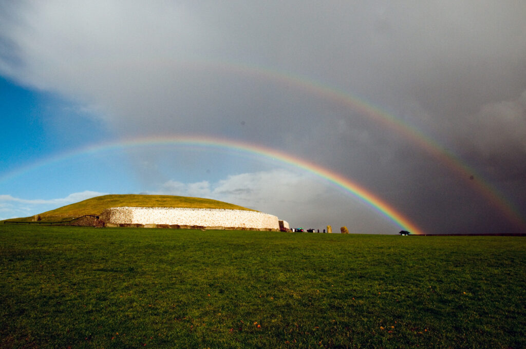 New Grange in Ireland, with a double rainbow