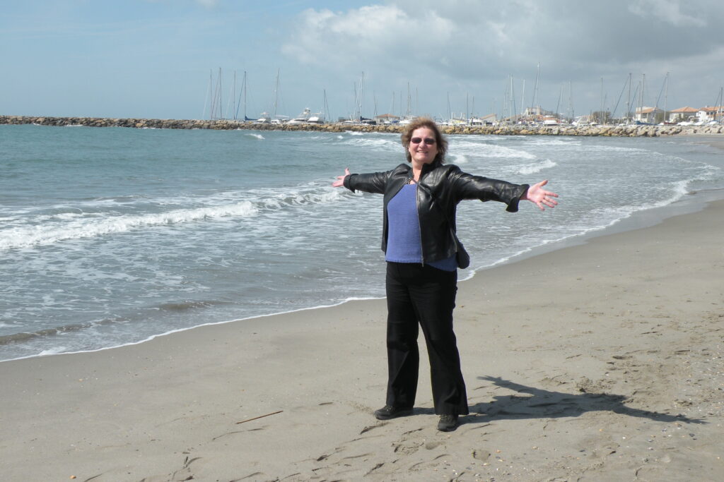 Carol Cram on the beach near Saintes-Marie-de-la-Mer, one of my recommended places to visit in France,