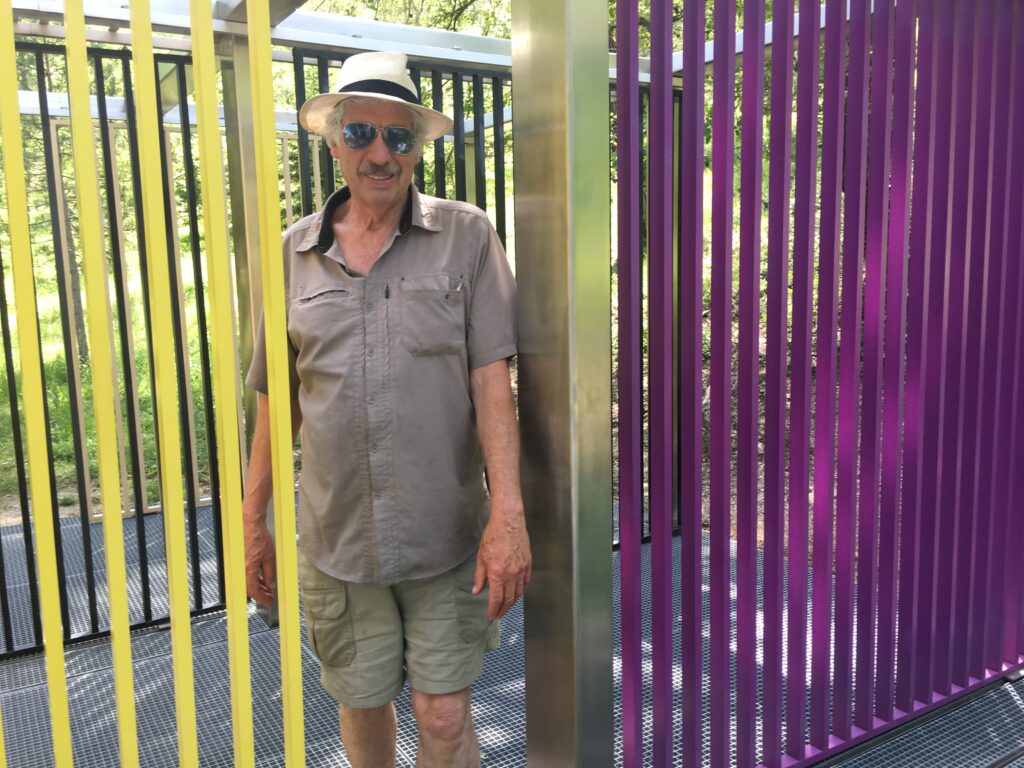 Gregg walking through a colorful sculpture