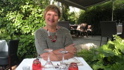 Carol Cram enjoying dinner next to a canal in the Dordogne