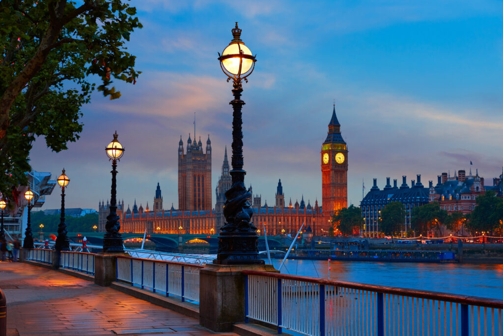 Sunset over Big Ben, the Parliament buildings and the Thames River in London, England