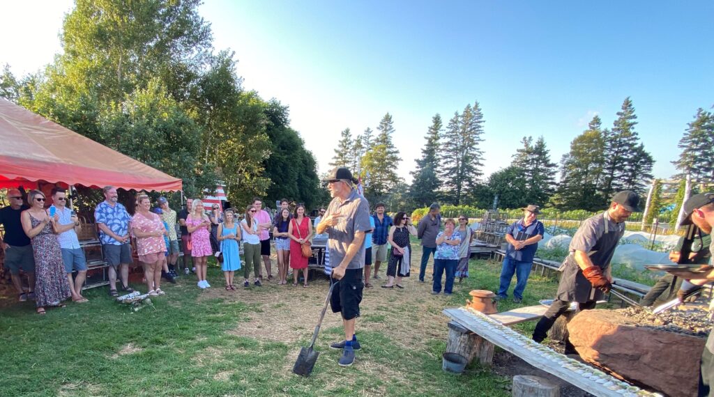 Chef Michael Smith greets guests in front of roasting oysters at the Inn at Bay Fortune for the FireWorks Feast