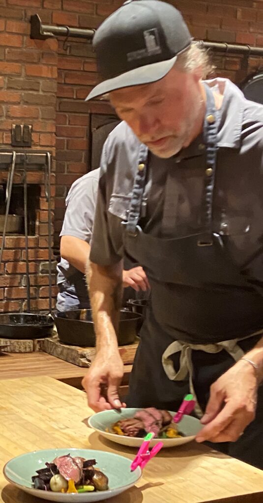 Chef Michael Smith preparing a main course