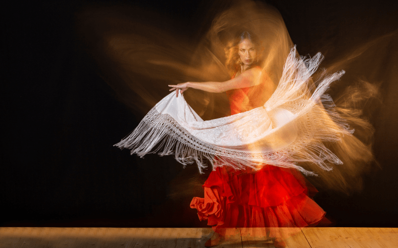 A flamenco dancer dressed in red; a flamenco performance is not to be missed while traveling in Seville, Spain