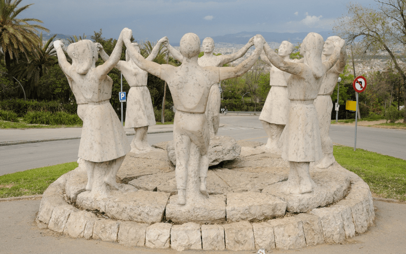 Statue featuring several figures dancing the Sardana, a traditional dance in Barcelona, Spain