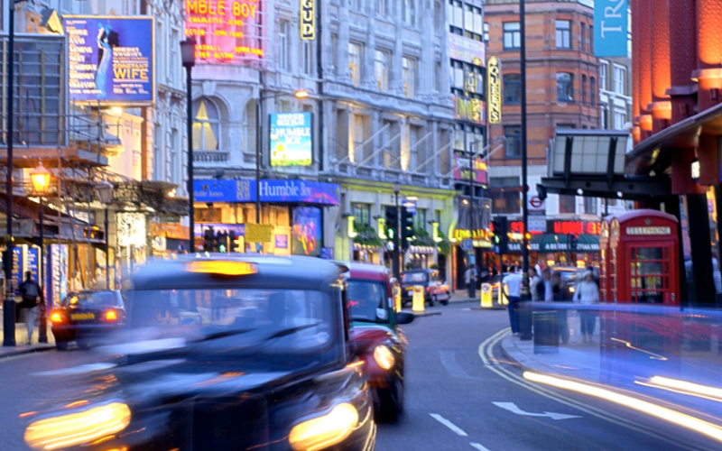 View of a street in London's busy west end theater district; visit London to see plenty of awesome concerts and performances while traveling in Europe.
