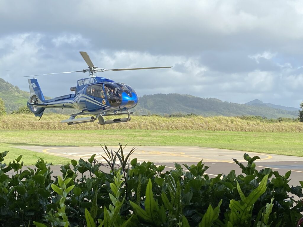 A highlight of a Kauai vacation is a  helicopter ride; picture here is a Blue Hawaiian helicopter coming in for a landing on Kauai