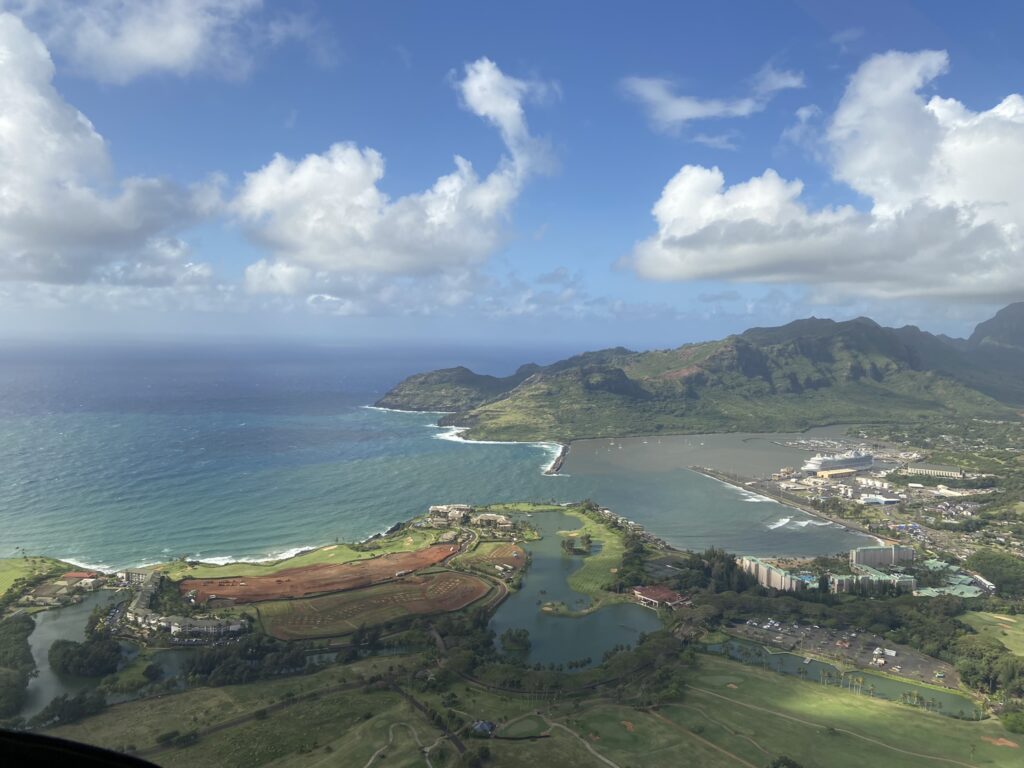 Taking off from Lihue airport in a Blue Hawaiian helicopter and heading south over a view of sea and land--a highlight of a Kauai vacation.