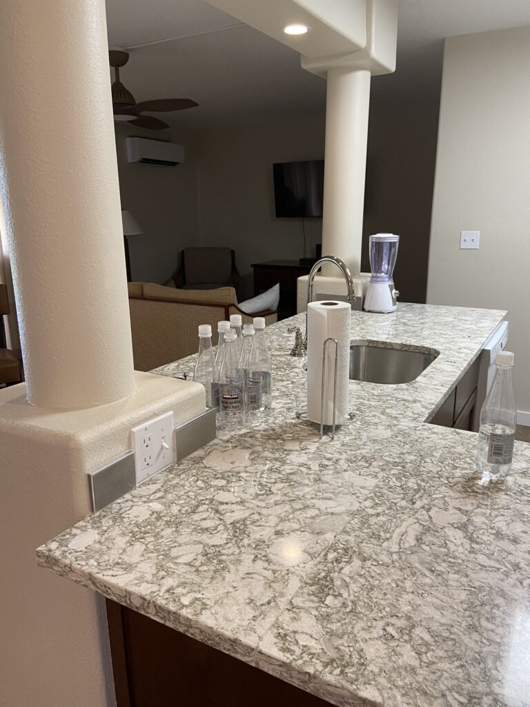 View of a kitchen with marble counter tops and pillars at the Kauai Beach Villas on Kauai