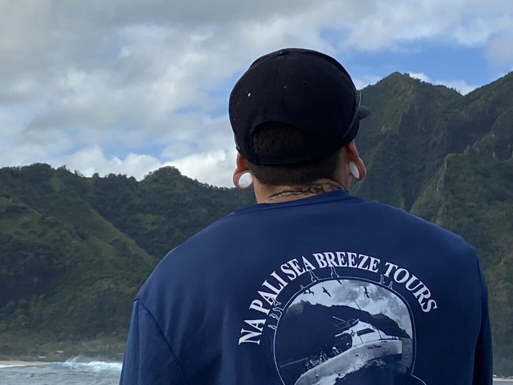 Back of a crew member on the Napali Sea Breeze Tours