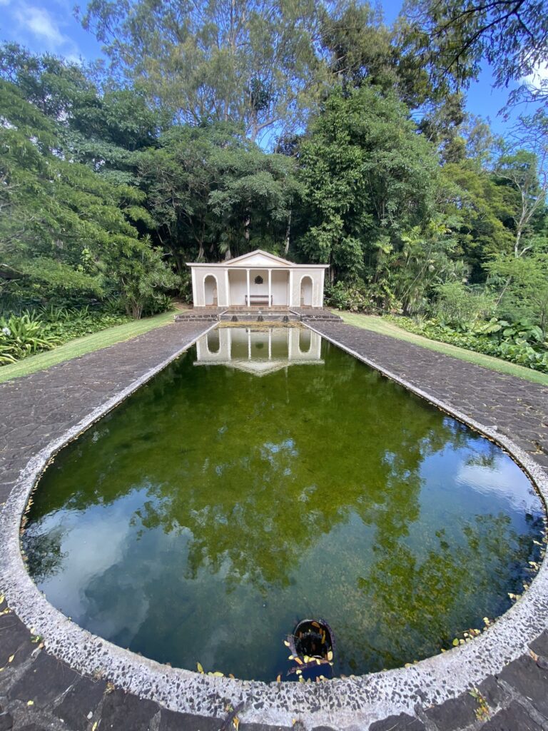 Classical-looking temple and an oval reflecting pool featured at the Allerton Gardens in Kauai.