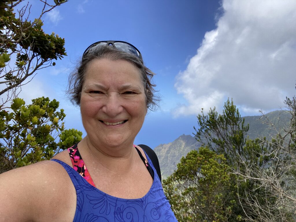 The author in front of the Kalalau Valley Lookout on Kauai. A visit to this lookout is a highlight of a trip of Kauai.