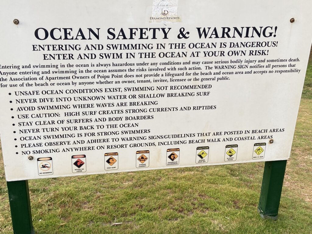 Sign listing the guidelines for safe swimming from a Kauai beach