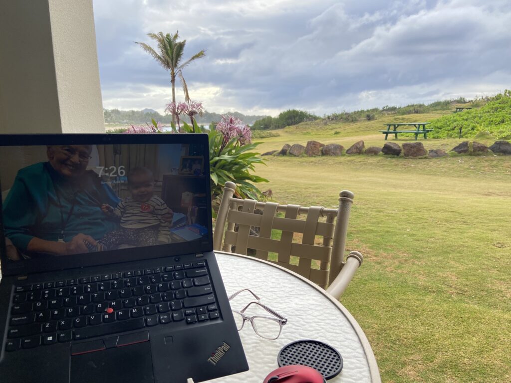 View of the Pacific Ocean with a laptop computer in the foreground from the author's suite at the Point at Poipu on Kauai's South Shore