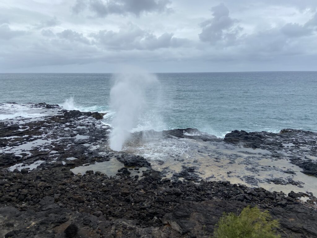 View of sea water blown into the air at Spouting Horn on Kauai's South Shore.