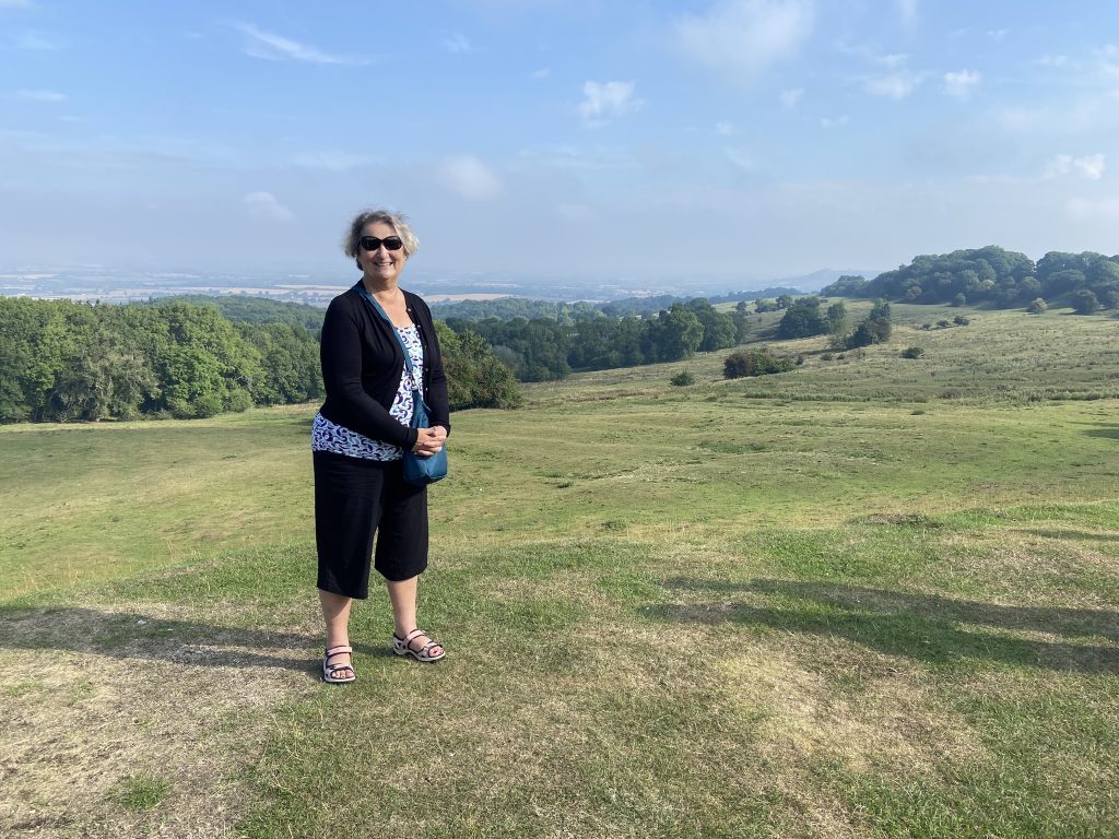 Carol Cram atop Dover Hill overlooking the Vale of Evesham in the Cotswolds in England