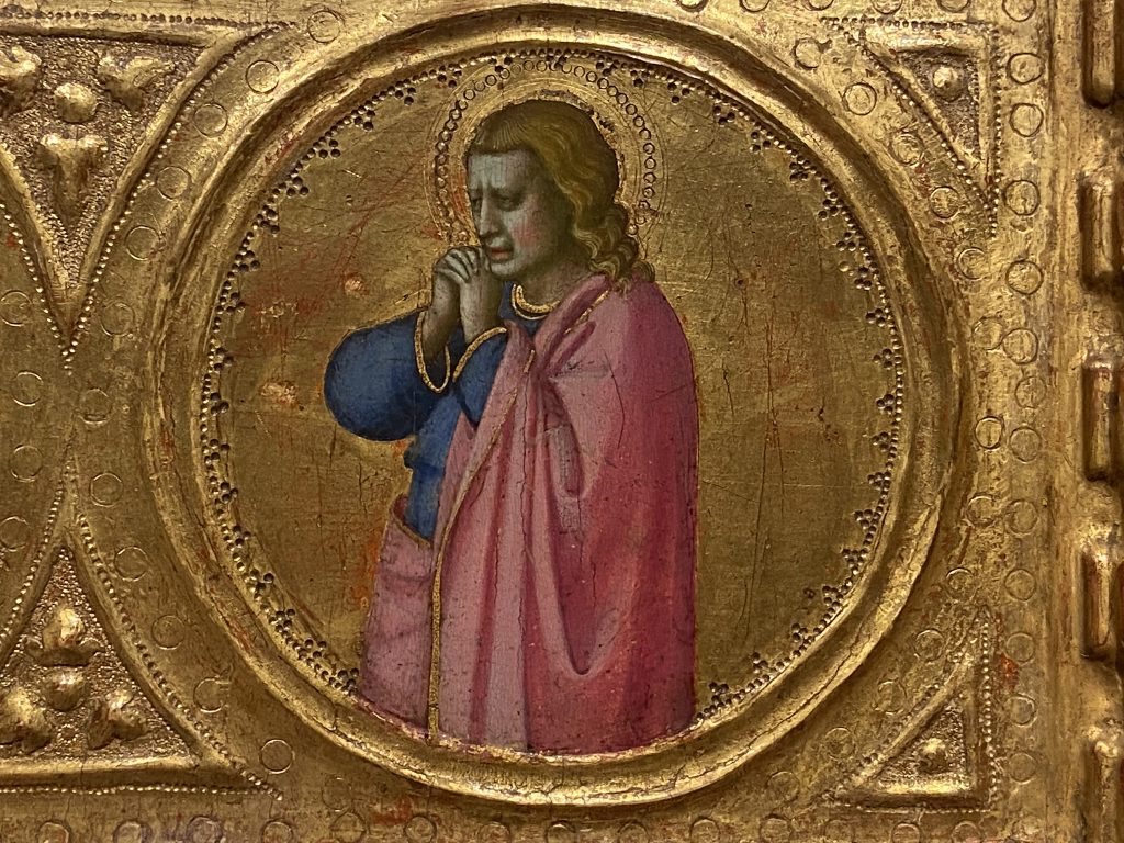 Medieval gold panel that includes a portrait of a female saint dressed in a pink cloak and created by Fra Angelico included in the Medieval collection at the Courtauld Gallery in London.
