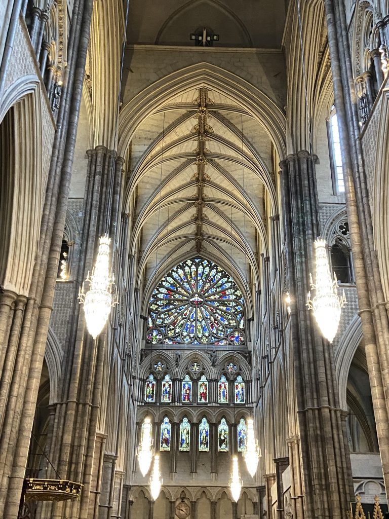 Interior of Westminster Abbey in London facing the large window at the rear