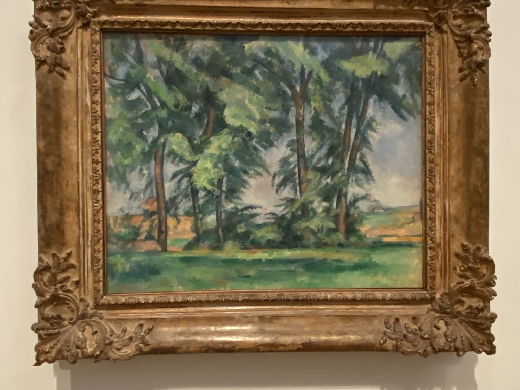 Image of the painting entitled "all Trees at the Jas de Bouffan" showing a row of trees in Provence by Paul Cezanne included in the Impressionist collection at the Courtauld Gallery in London.