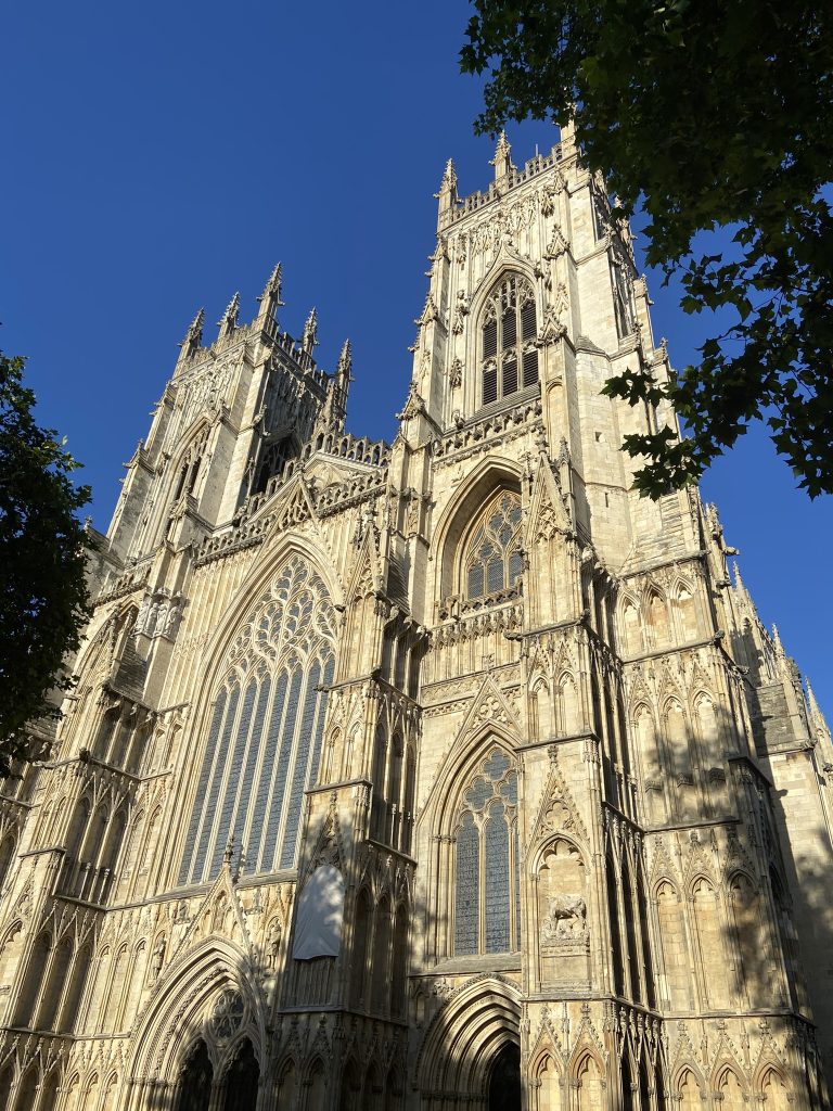 York Minster facade on a bright sunny day with a blue sky