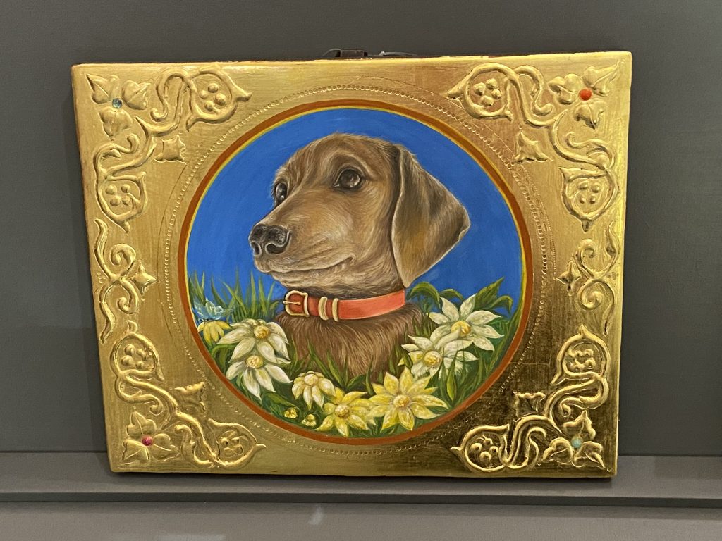 Painting on a gold background of a dachshund