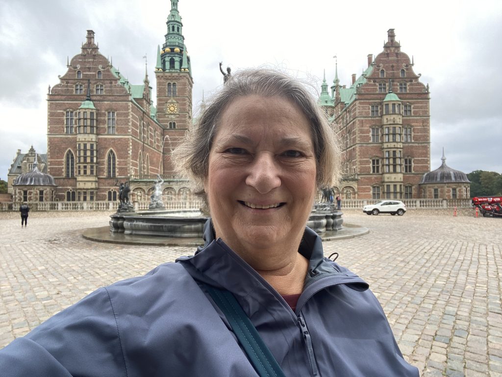 Carol Cram in front of Fredericksberg Castle near Hillerød outside Copenhagen - a perfect day trip from Copenhagen