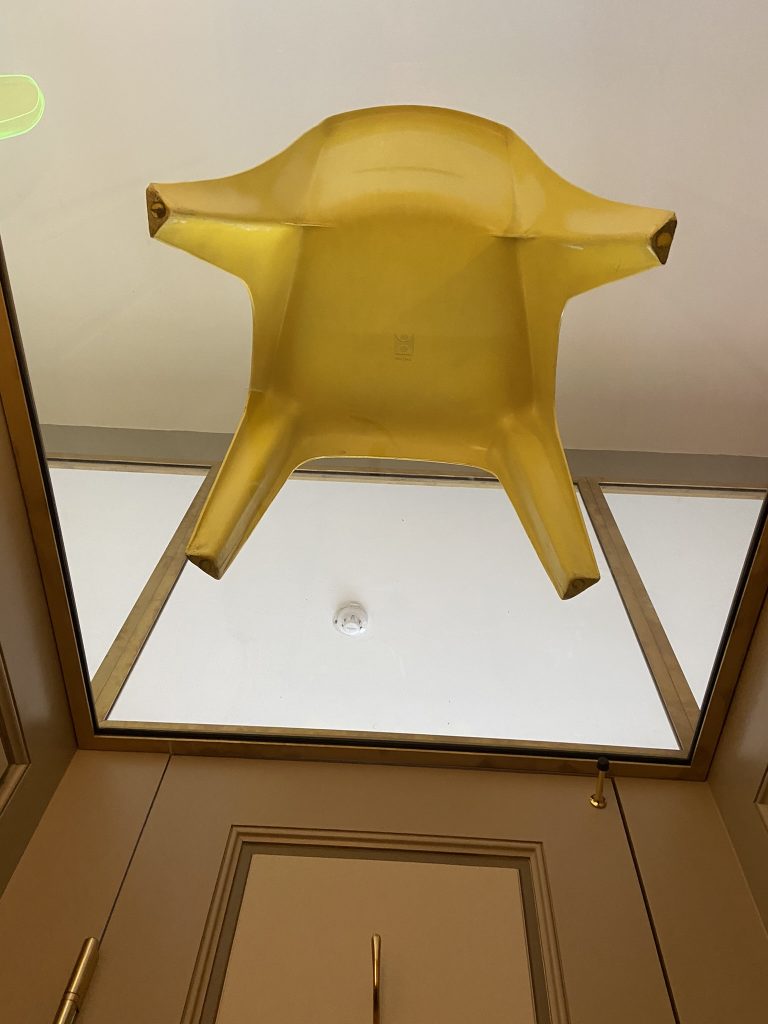 Plastic chair above a toilet stall at the Design Museum in Copenhagen