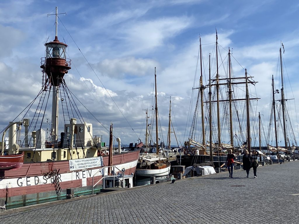 Lively harbor with tall ships in Helsingør