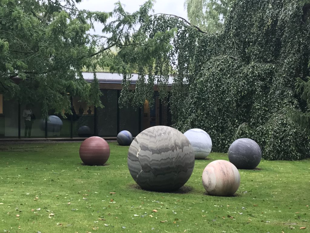 Stone spheres outside in the sculpture garden at the Louisiana Museum of Modern Art