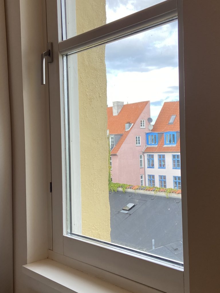 Colorful rooftops of Copenhagen seen from the bedroom of the apartment in Copenhagen