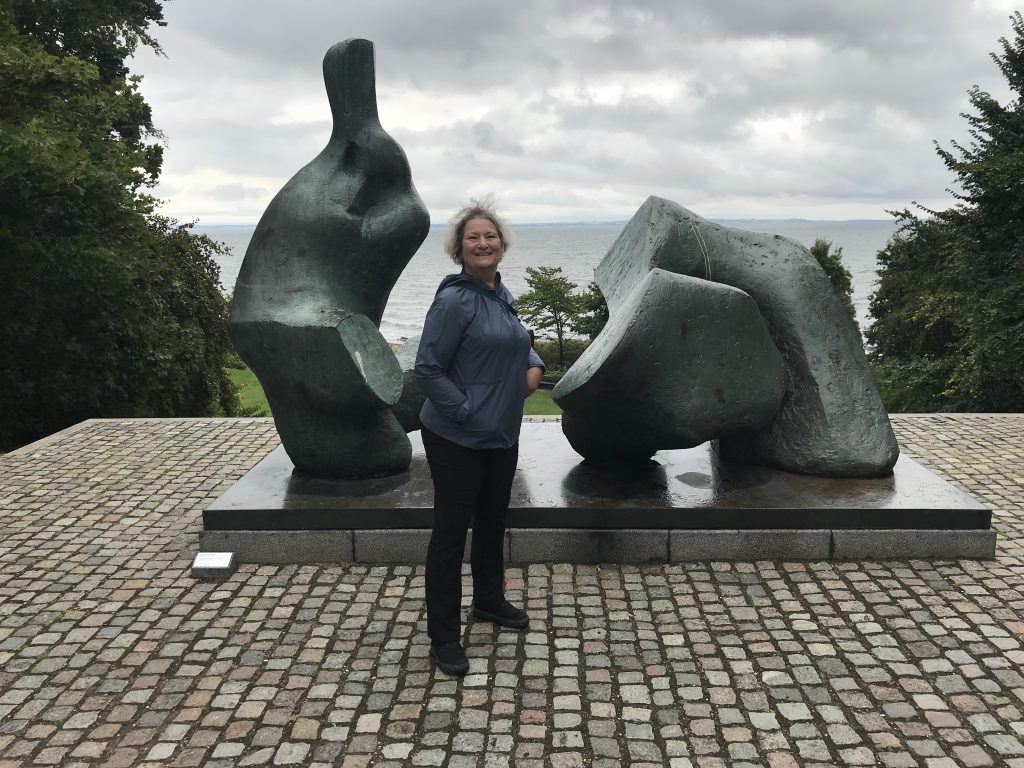 Carol Cram in front of a modern sculpture at the Louisiana Museum of Modern Art