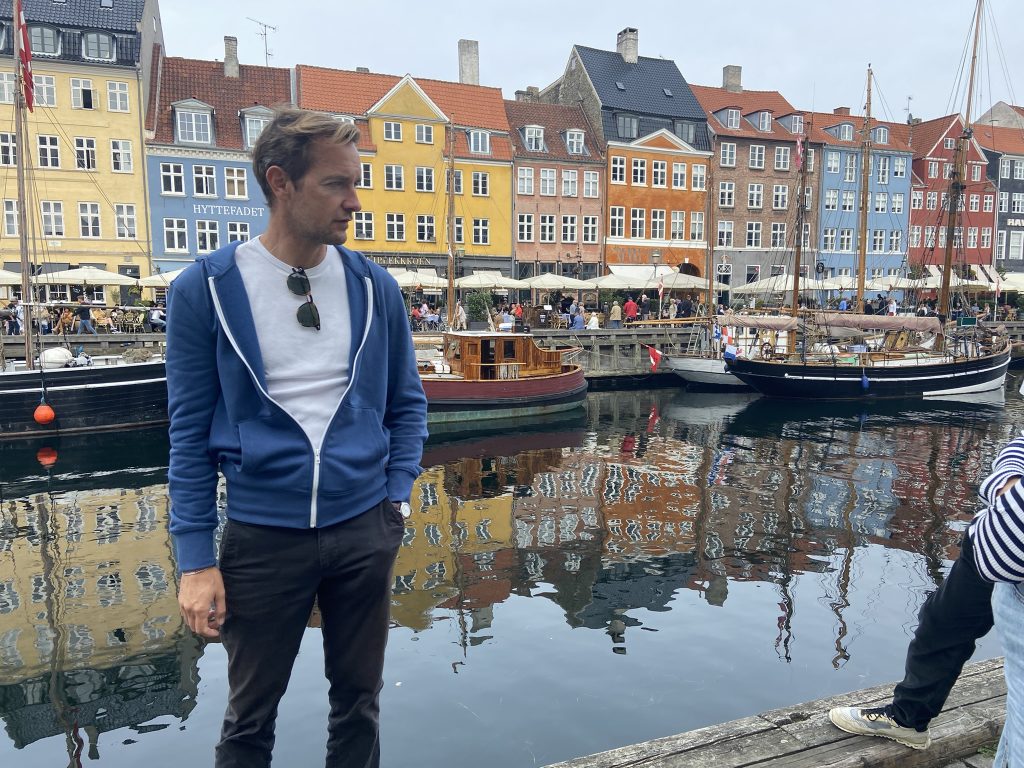 Guide standing in front of Nyhavn harbor in Copenhagen