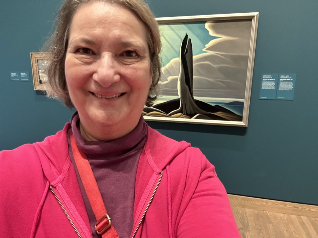 Carol Cram in front of North Shore, Lake Superior, a painting by Lawren Harris at the National Gallery of Canada