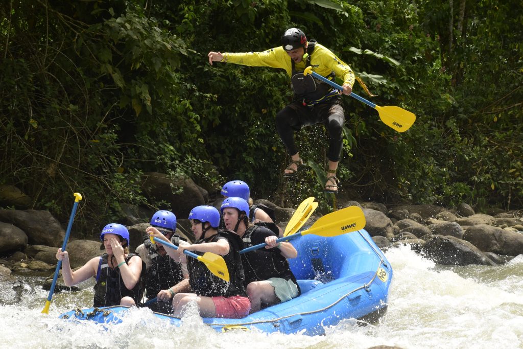 Our Guide jumps off the raft on the River Bosa whitewater rafting in Costa Rica