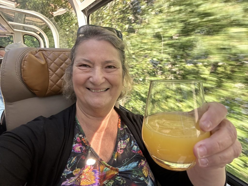Carol enjoying a mimosa on the Rocky Mountaineer 