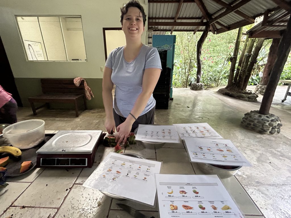 Julia chopping fruit while volunteering at Proyecto Asis